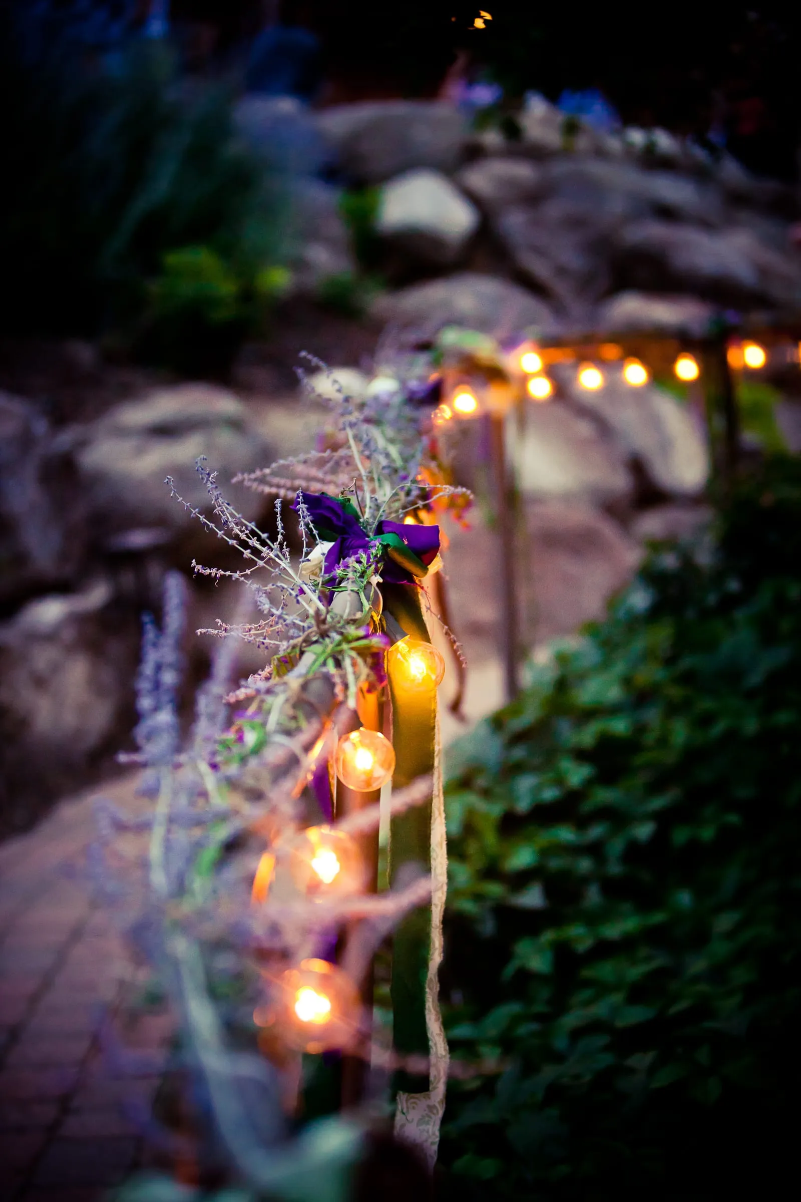 Twinkle lights and flowers decorating a garden reception