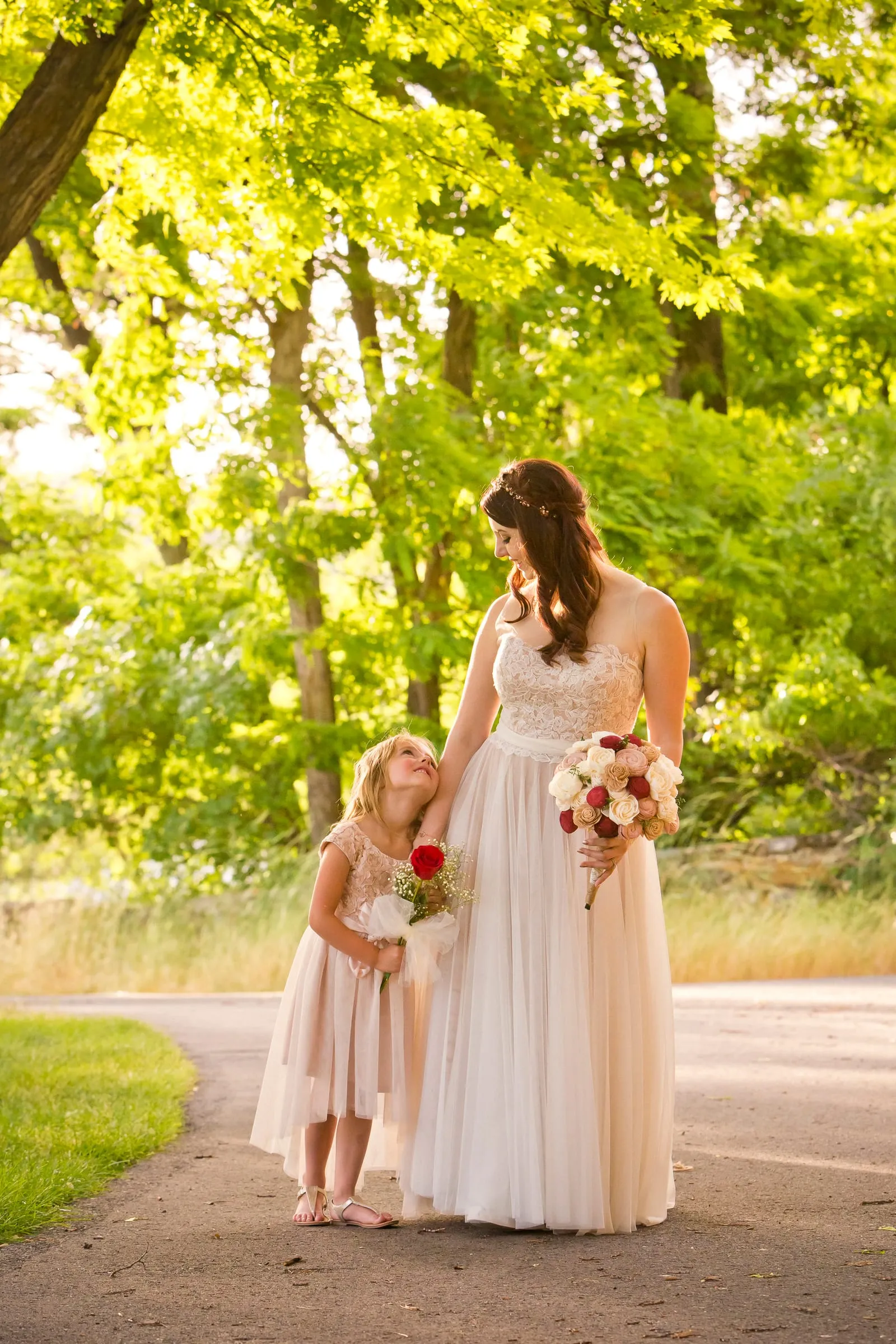 Bride walking hand in hand with a little flower girl