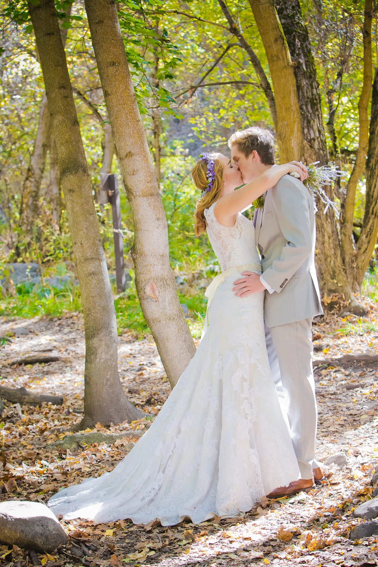 Couple kissing among tall aspen trees