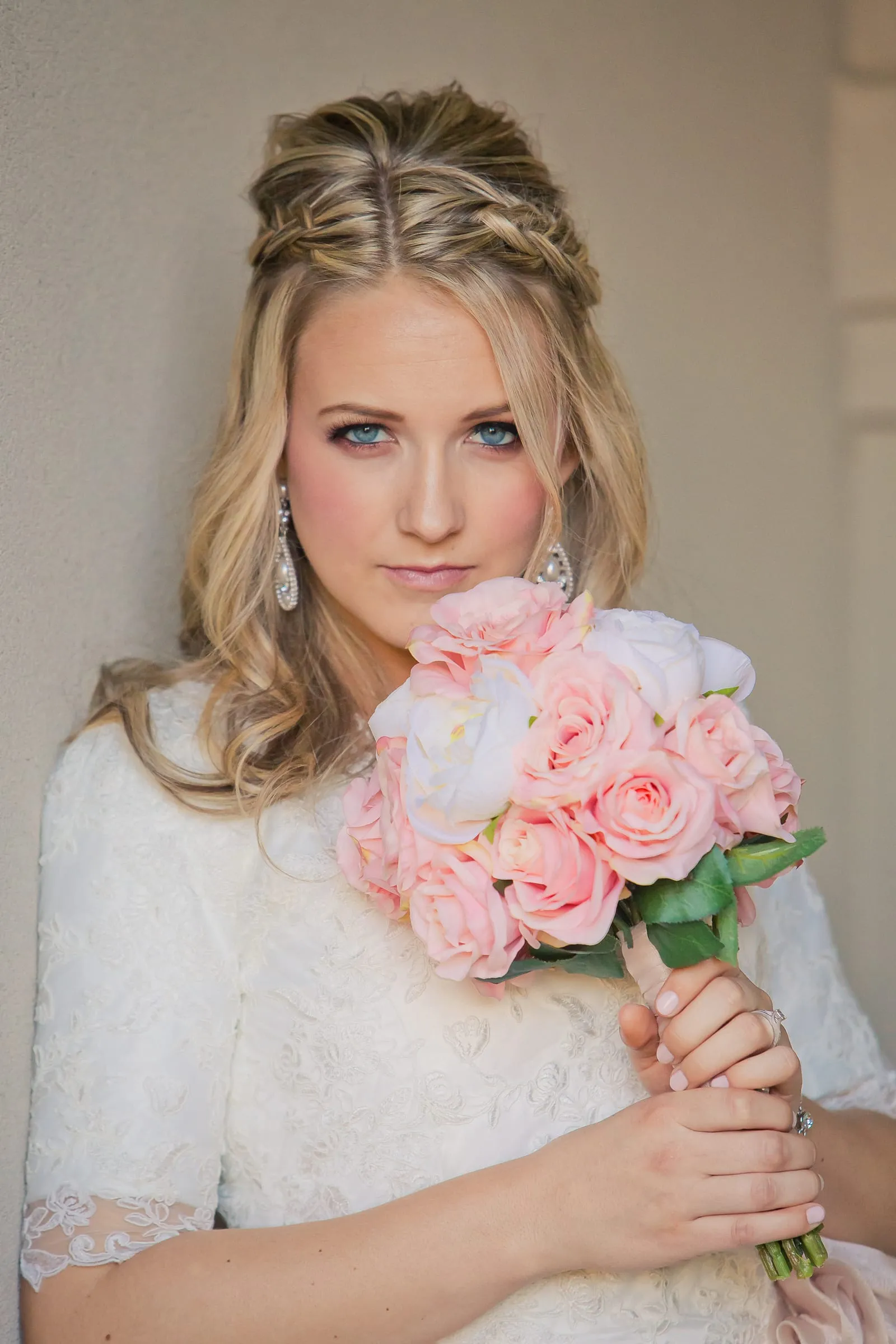 Bride holding a bouquet of pink roses