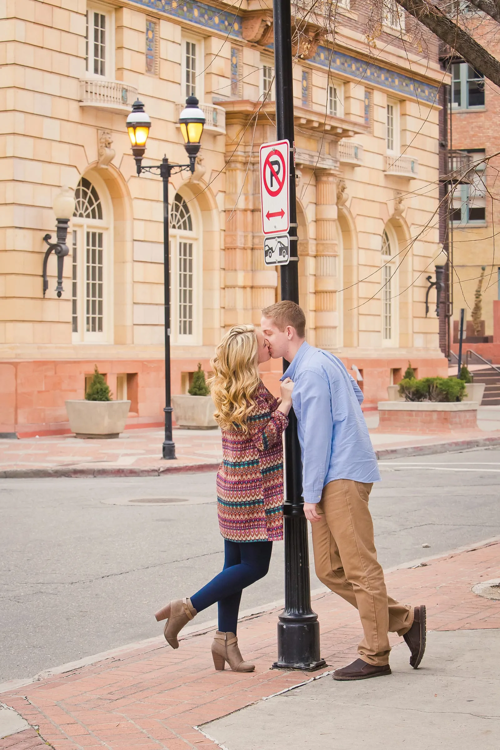 Engaged couple strolling down a historic downtown street