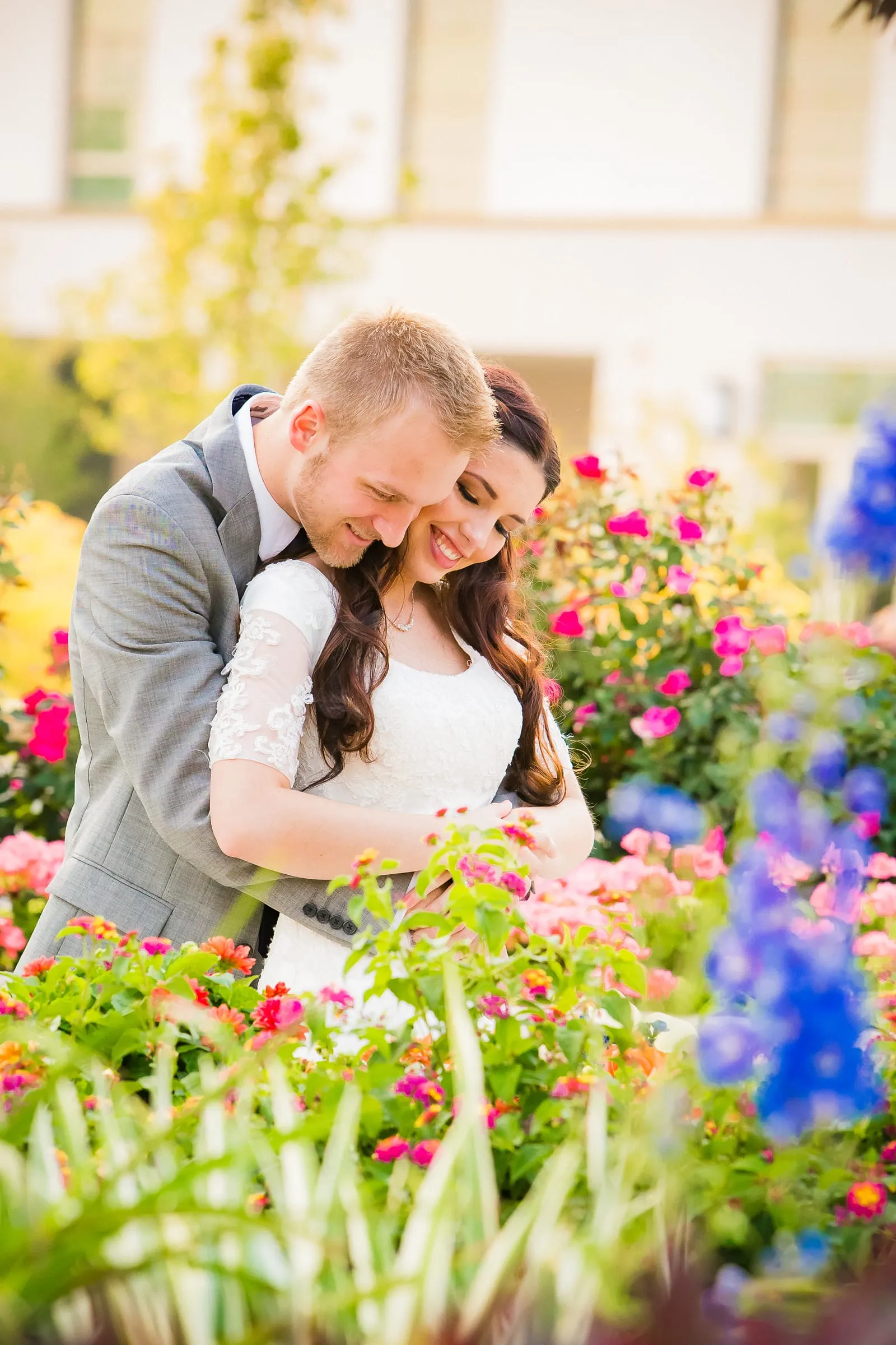 Couple surrounded by colorful garden flowers